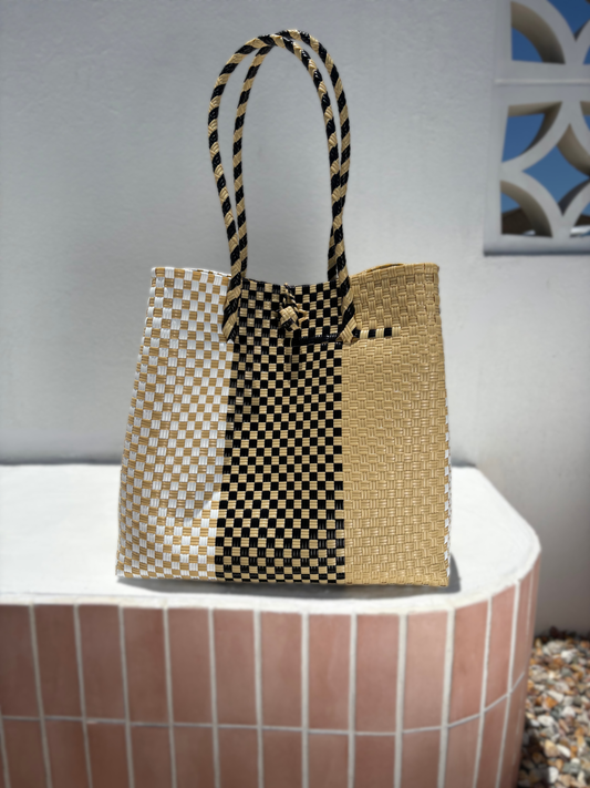 Woven bag with black pattern on a white surface